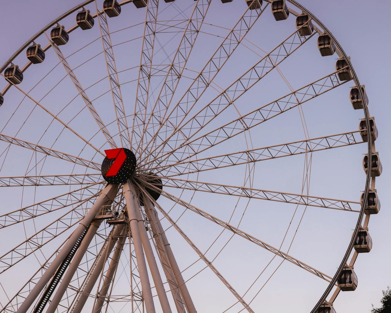 home-img A large ferris wheel against a sunset sky in Brisbane, Australia.